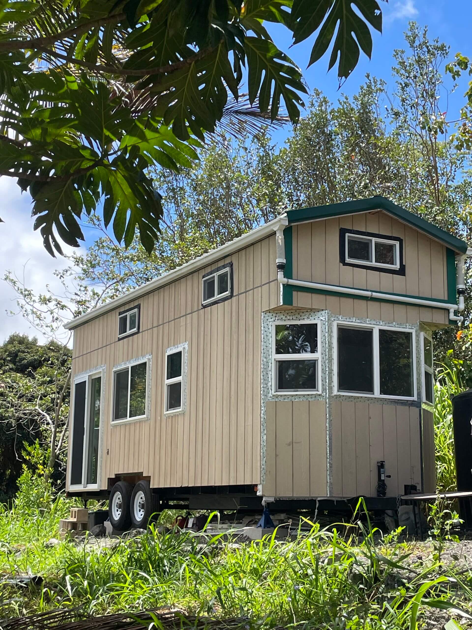 Tiny home rental near Rainbow Bridge Hawaii surrounded by tropical greenery, available for lucid dream retreat lodging