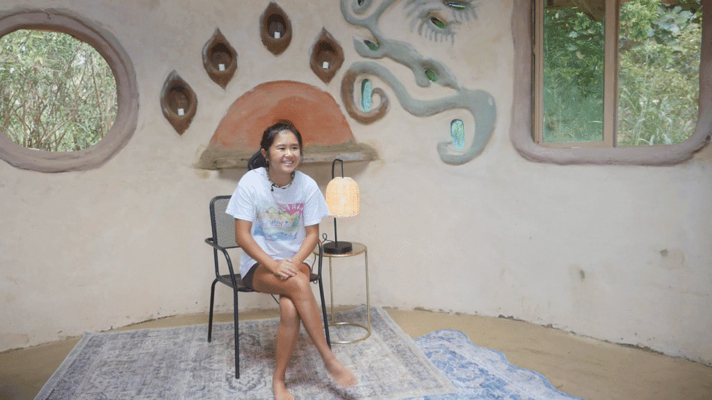 Work trader sharing a testimonial inside a natural building at Rainbow Bridge Hawaii.