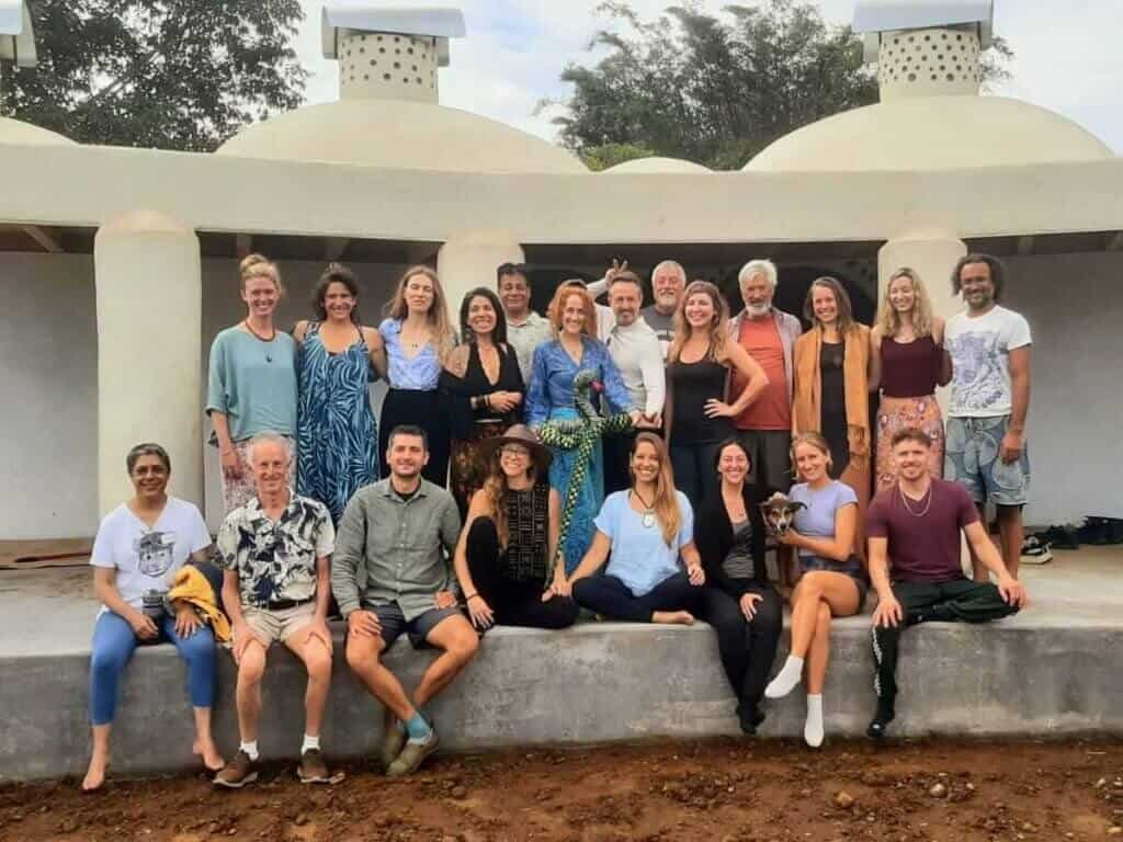Healing Dreams Retreat participants gathered in front of the Aesklepion Dream Temple at Rainbow Bridge Hawaii.