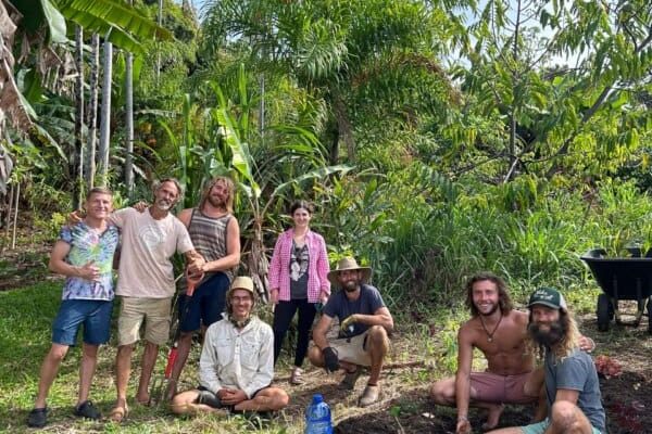 Group of community members gathered for a garden work day at Rainbow Bridge Hawaii, celebrating land stewardship and shared effort